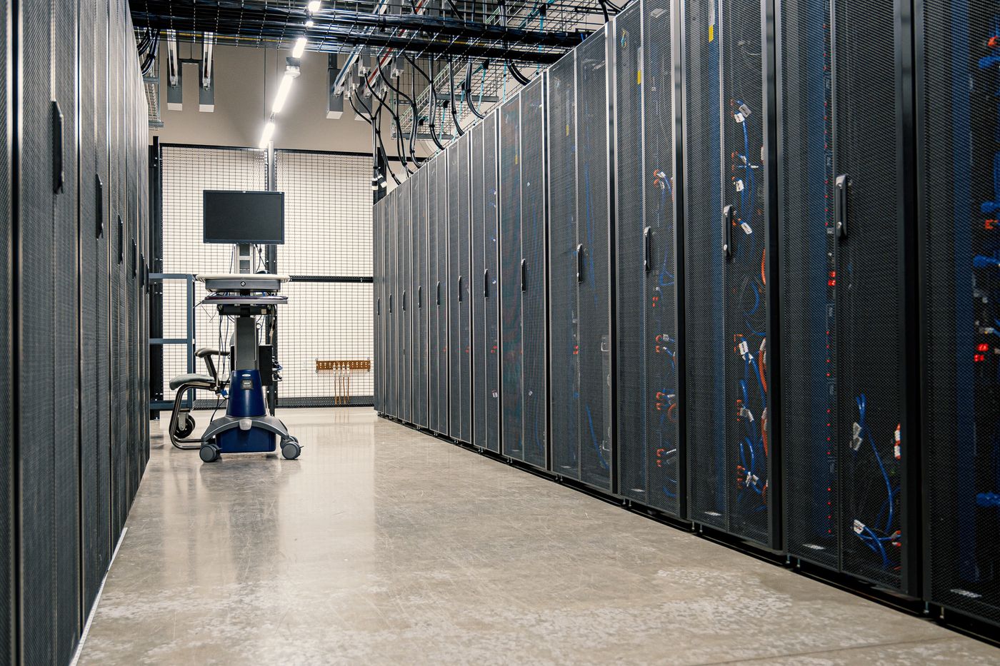 Data centre corridor lined with server racks